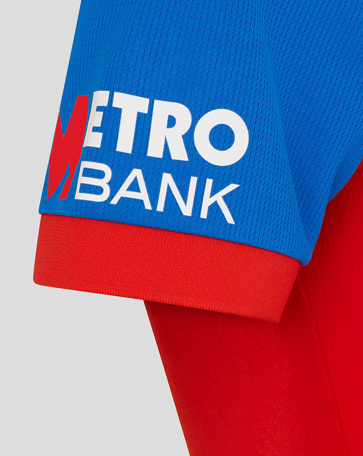 Blue T20 shirt sleeve with Metro Bank sponsor logo on a red cuff