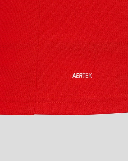 Close-up of red jersey fabric with white AERTEK branding.