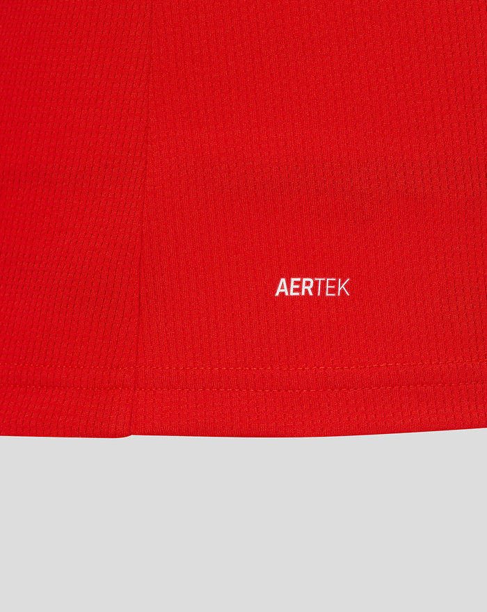 Close-up of red jersey fabric with white AERTEK branding.