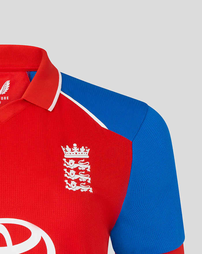 Close up of red England T20 short sleeve shirt with blue sleeve panel and white crest on the chest