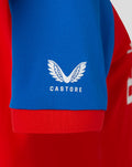 Blue sleeve close-up showing the white Castore wing emblem on the shirt