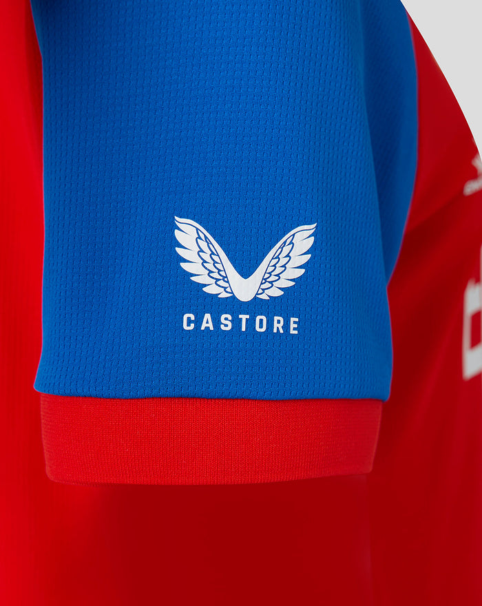 Blue sleeve close-up showing the white Castore wing emblem on the shirt
