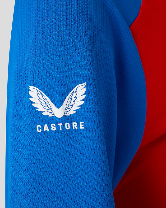 Blue sleeve detail featuring the Castore wing logo and CASTORE wordmark