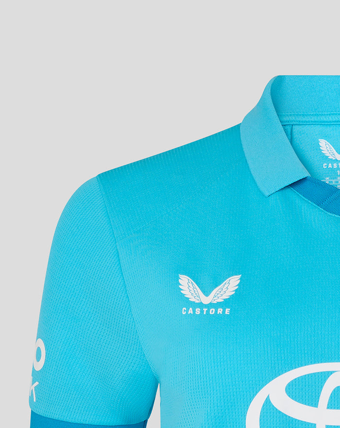Blue shirt chest displays Castore branding with white wing emblem.