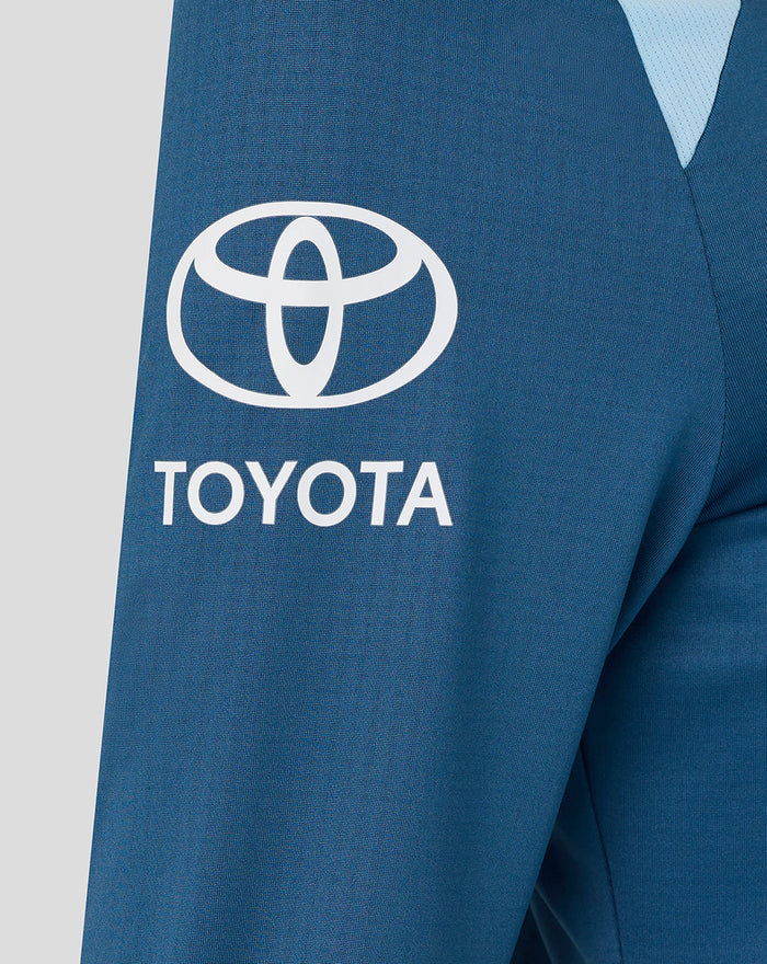 Sleeve view of blue training top featuring Toyota sponsor logo on the sleeve.
