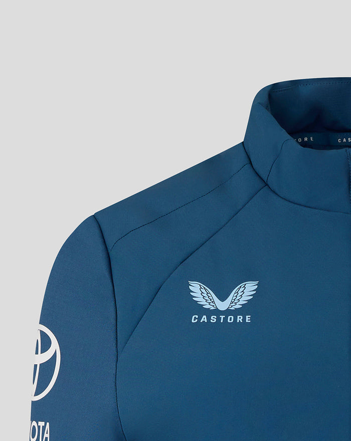 Close up of the blue jacket chest with Castore emblem featuring a wing design and Toyota branding on the sleeve