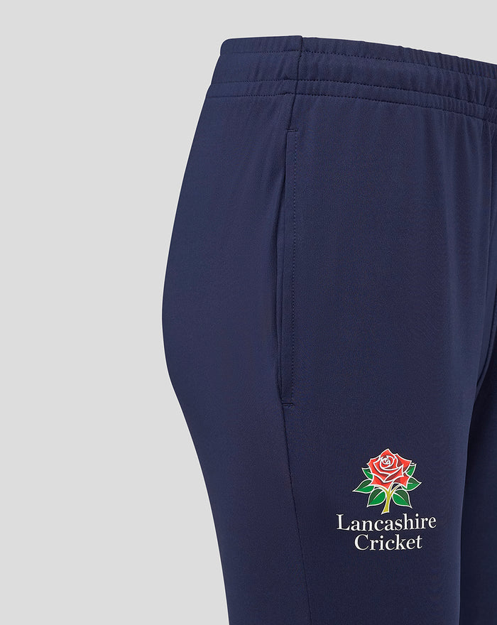 Close up of navy Lancashire Slim Fit Pant side seam showing the Lancashire Cricket rose logo near the lower leg.