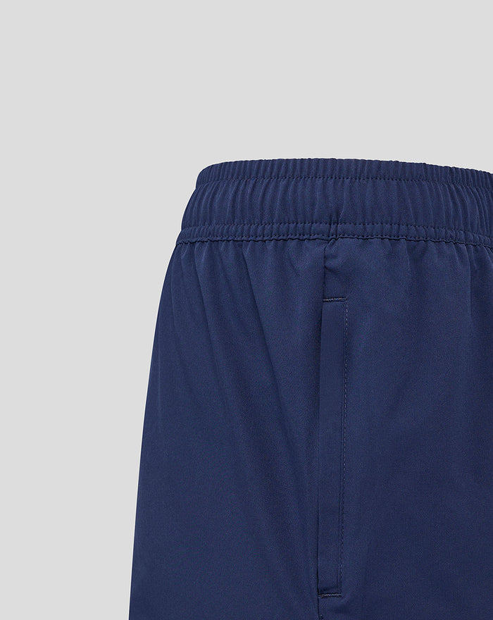 Close-up side back view of navy woven training shorts showing elastic waistband and side seam pocket