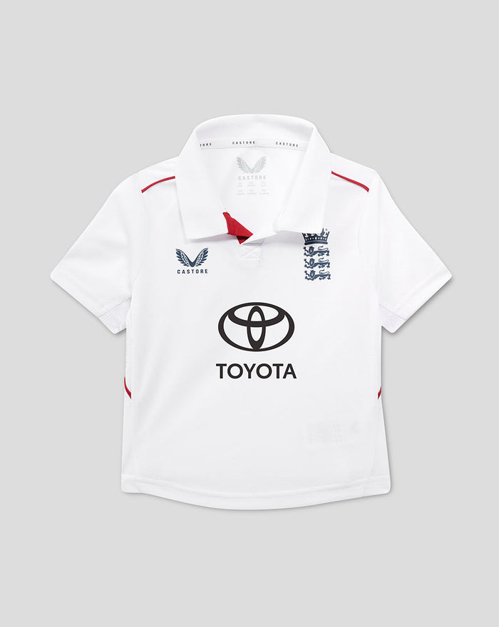 Infant white England Test cricket shirt with navy three lions crest and Toyota sponsor logo on front for young supporters.