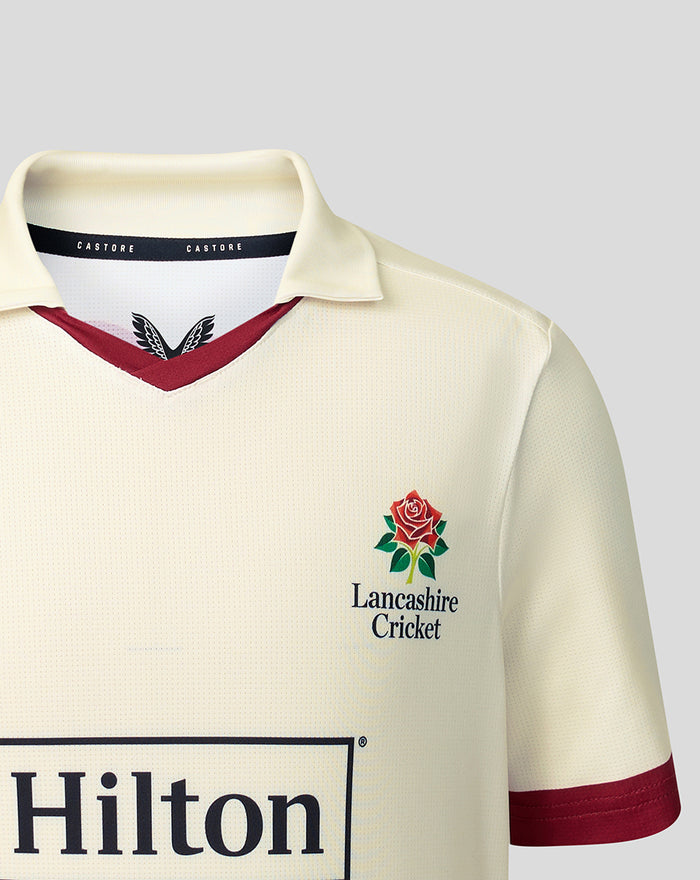 Cream jersey front displaying Lancashire Cricket crest and Hilton sponsor across the chest.