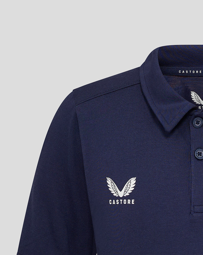 Close up of navy polo chest highlighting the Castore wing logo on the left with textured fabric and collar detail