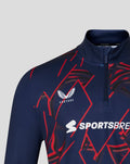 Close-up of navy quarter zip collar and chest showing crest, Castore branding and Sportsbreaks logo.
