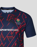 Shoulder and chest close-up of navy T-shirt showing red geometric pattern and Sportsbreaks branding with Lancashire Cricket emblem