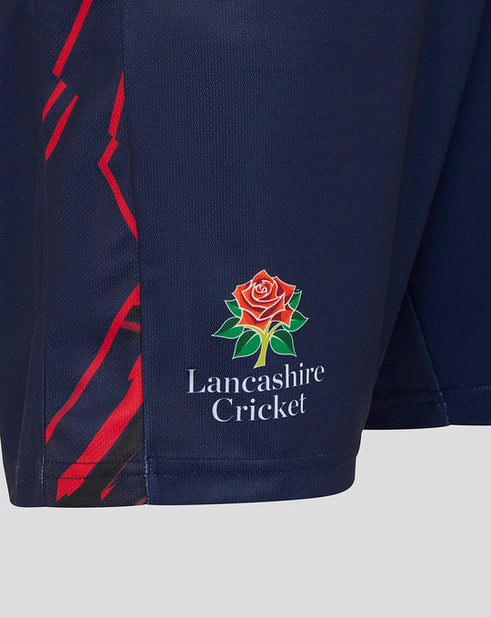 Close-up of navy shorts showing the Lancashire Cricket crest and red side graphics.
