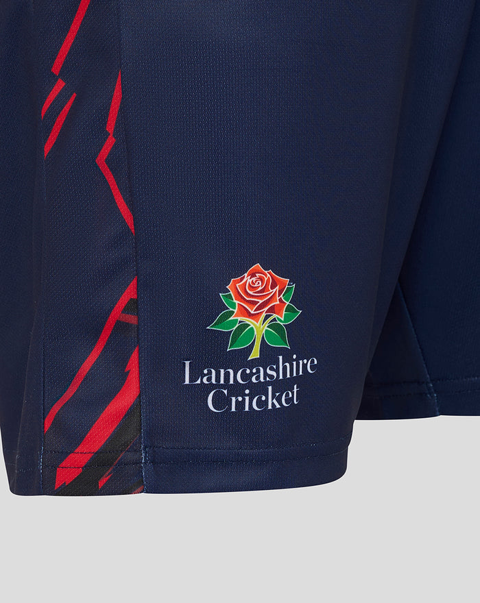Close-up of navy shorts showing the Lancashire Cricket crest and red side graphics.