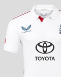 Close up of the white England cricket shirt chest with Castore logo on the left and Toyota emblem center and red shoulder piping.