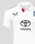 Close up of a white polo cricket shirt showing Castore branding on the left chest and a red sleeve stripe.