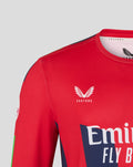 Close-up of red long sleeve jersey showing Castore logo near the collar and fabric texture