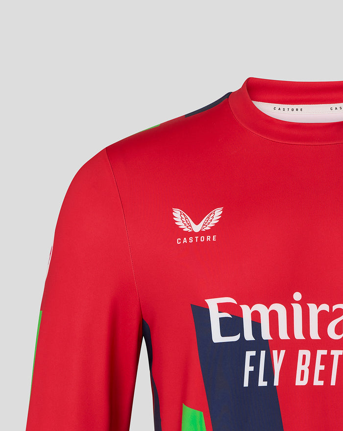Red sweatshirt chest showing Castore emblem and Emirates Fly Better branding with navy and green graphics.
