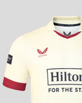 Chest close-up of cream Lancashire County Championship jersey showing red rose crest and Hilton sponsor with Castore collar detail.