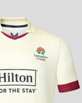 Front view of cream Lancashire County Championship jersey with Hilton sponsor across chest and maroon sleeve trim.