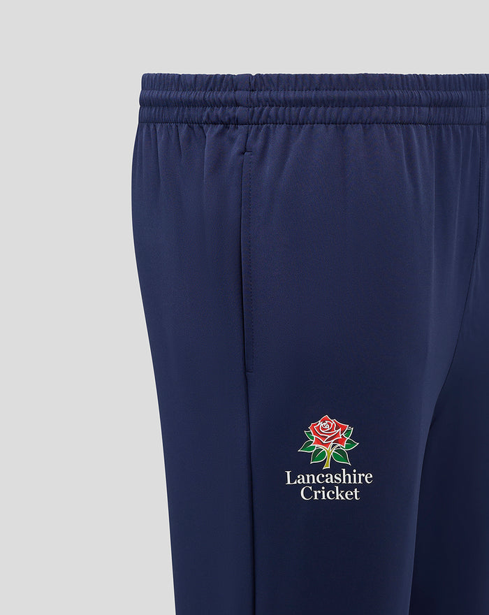 Side close up of navy Lancashire Track Pant showing embroidered rose Lancashire Cricket logo and text on the thigh