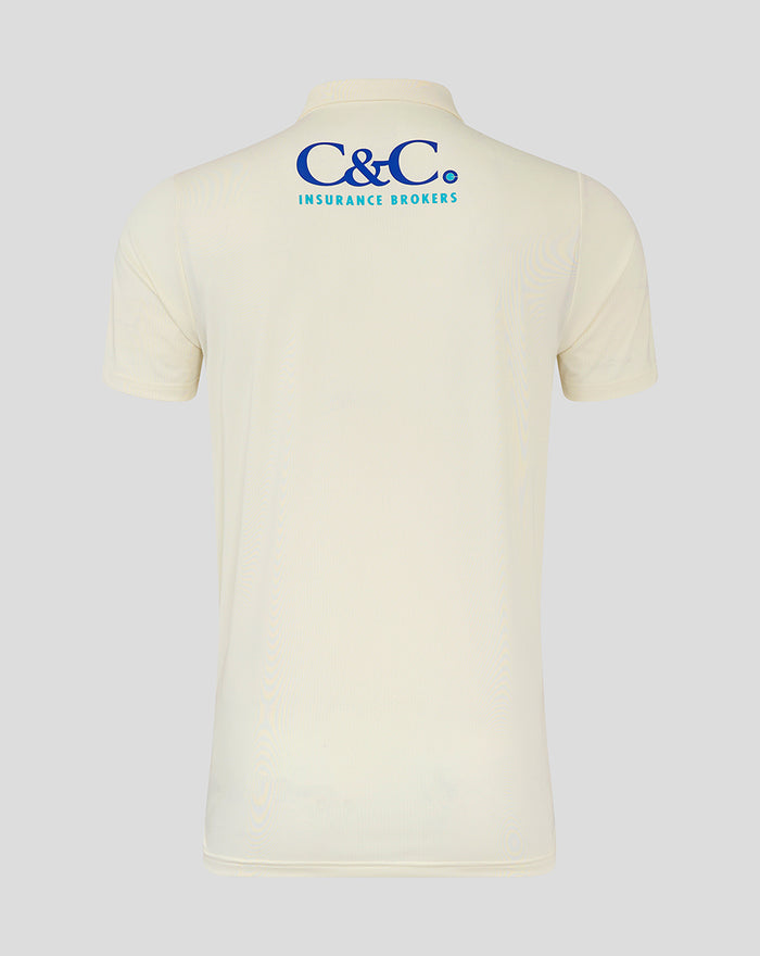 Back view of beige Lancashire cricket jersey featuring blue C&C Insurance Brokers logo at the upper back